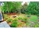 Lush backyard view showcasing beautiful landscaping, a trampoline, pond and footbridge at 1178 Chambord Ne Way, Brookhaven, GA 30319