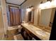 Bathroom with double sink vanity, granite countertops, and decorative baskets at 1178 Chambord Ne Way, Brookhaven, GA 30319