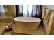 Luxurious bathroom features a freestanding tub, elegant fixtures, and marble tile at 1178 Chambord Ne Way, Brookhaven, GA 30319