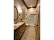 Bathroom with a decorative vanity, oval mirror, and a glass-enclosed shower with elegant tile work at 1178 Chambord Ne Way, Brookhaven, GA 30319