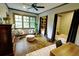 Bedroom boasts hardwood floors, ceiling fan, and window with lots of natural light at 1178 Chambord Ne Way, Brookhaven, GA 30319