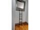 Bedroom closet with ladder for access to the upper storage area and hardwood floors at 1178 Chambord Ne Way, Brookhaven, GA 30319