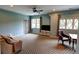 Bonus room featuring a blue accent wall, plush carpet, and lots of natural light at 1178 Chambord Ne Way, Brookhaven, GA 30319