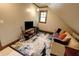 Bonus room with large rug, sofa and accent pillows plus hardwood trim at 1178 Chambord Ne Way, Brookhaven, GA 30319