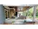 Charming covered patio featuring a stone fireplace, comfortable seating, and a well-manicured backyard at 1178 Chambord Ne Way, Brookhaven, GA 30319