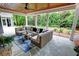 Inviting covered patio featuring comfortable seating, a ceiling fan, and views of the lush backyard at 1178 Chambord Ne Way, Brookhaven, GA 30319