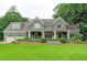 Charming gray home featuring a large front yard, covered porch, and a two-car garage at 1178 Chambord Ne Way, Brookhaven, GA 30319