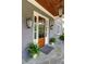 Elegant front entrance boasts stone floor, wood paneled door, and decorative outdoor lighting at 1178 Chambord Ne Way, Brookhaven, GA 30319
