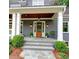 Classic front entry featuring a wood door flanked by wall sconces and a stone walkway at 1178 Chambord Ne Way, Brookhaven, GA 30319