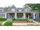 Inviting front porch with stately columns, ceiling fans, and cozy seating with an impressive flower bed at 1178 Chambord Ne Way, Brookhaven, GA 30319