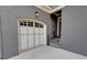 Attached two-car garage showcasing carriage-style doors and a covered entry at 1178 Chambord Ne Way, Brookhaven, GA 30319