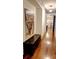 Hallway features hardwood floors, a bench, and decorative artwork, leading to the staircase at 1178 Chambord Ne Way, Brookhaven, GA 30319