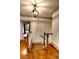 Upstairs hallway with hardwood floors, elegant lighting, and an open doorway at 1178 Chambord Ne Way, Brookhaven, GA 30319