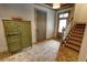 Hallway featuring brick floors, vintage armoire, staircase with carpet runner, and abundant natural light at 1178 Chambord Ne Way, Brookhaven, GA 30319