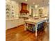 Bright kitchen featuring custom cabinets, marble countertops, large island, and professional stainless steel appliances at 1178 Chambord Ne Way, Brookhaven, GA 30319