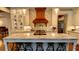 Gourmet kitchen with custom cabinets, marble counters, oversized island with seating, and stainless steel appliances at 1178 Chambord Ne Way, Brookhaven, GA 30319