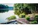 A tranquil view of a serene lake, surrounded by lush greenery, with a landscaped stone patio in the foreground at 1178 Chambord Ne Way, Brookhaven, GA 30319