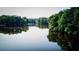 Scenic lake view reflecting the lush, green trees on the calm waters of the lake at 1178 Chambord Ne Way, Brookhaven, GA 30319