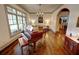 Classic living room features hardwood floors, piano, chandelier, and arched doorways at 1178 Chambord Ne Way, Brookhaven, GA 30319