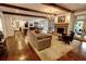 Open-concept living room with hardwood floors, fireplace, exposed beams, and view of the kitchen at 1178 Chambord Ne Way, Brookhaven, GA 30319