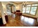 Elegant living room with a piano, hardwood floors, chandelier and large windows with natural light at 1178 Chambord Ne Way, Brookhaven, GA 30319