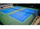 Overhead aerial view of the two newly resurfaced outdoor tennis courts with blue surface at 1178 Chambord Ne Way, Brookhaven, GA 30319