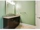 Bathroom featuring light green walls, vanity with mirror and a white door at 3821 Chamblee Dunwoody Rd, Atlanta, GA 30341