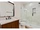 Modern bathroom featuring a dark vanity, marble countertop, and frameless glass shower at 3821 Chamblee Dunwoody Rd, Atlanta, GA 30341