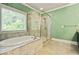 Luxurious bathroom featuring a soaking tub, separate shower, and tile flooring at 3821 Chamblee Dunwoody Rd, Atlanta, GA 30341
