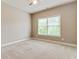 Bright bedroom with a neutral color scheme, plush carpeting, and a window view at 3821 Chamblee Dunwoody Rd, Atlanta, GA 30341