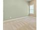 Bright and airy bedroom featuring neutral walls, a window for natural light, and plush carpeting at 3821 Chamblee Dunwoody Rd, Atlanta, GA 30341