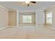 Expansive bedroom featuring plush carpeting, modern lighting, and large windows at 3821 Chamblee Dunwoody Rd, Atlanta, GA 30341