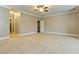 Large empty bedroom with carpet flooring, ceiling fan, and neutral paint at 3821 Chamblee Dunwoody Rd, Atlanta, GA 30341