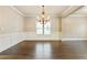 Elegant dining room with hardwood floors, decorative molding, and a stylish chandelier creating a warm atmosphere at 3821 Chamblee Dunwoody Rd, Atlanta, GA 30341