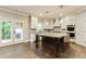 Modern kitchen featuring white cabinetry, stainless steel appliances, granite countertops, and a central island at 3821 Chamblee Dunwoody Rd, Atlanta, GA 30341