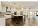 Modern kitchen featuring white cabinetry, stainless steel appliances, granite countertops, and a central island at 3821 Chamblee Dunwoody Rd, Atlanta, GA 30341