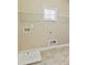 Laundry room with tile floor, overhead wire rack and utility sink at 3821 Chamblee Dunwoody Rd, Atlanta, GA 30341