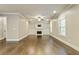 Spacious living room featuring hardwood floors, a cozy fireplace, built-in shelves, and ample natural light at 3821 Chamblee Dunwoody Rd, Atlanta, GA 30341