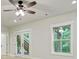 Bright living room features a ceiling fan and french doors leading to an outdoor staircase at 3821 Chamblee Dunwoody Rd, Atlanta, GA 30341