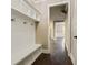 Mud room with white storage cubbies and bench seating with wood flooring at 3821 Chamblee Dunwoody Rd, Atlanta, GA 30341