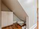 Attic nook with built-in storage, cozy pet bed, and rich hardwood floors, offering comfort and organization at 4446 Huntington Cir, Atlanta, GA 30338