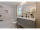 Bathroom offers tub and shower combo with bright white tiling and updated vanity at 4446 Huntington Cir, Atlanta, GA 30338