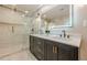 Modern bathroom boasting double sinks and a shower with frameless glass doors and gold hardware at 4446 Huntington Cir, Atlanta, GA 30338