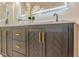 Close up on the vanity with black wood finish and gold accents in a renovated bathroom space at 4446 Huntington Cir, Atlanta, GA 30338