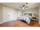 Bedroom boasts hardwood floors, a ceiling fan, and a large closet with painted doors at 4446 Huntington Cir, Atlanta, GA 30338