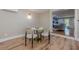 Small dining area with hardwood flooring, modern lighting, and marble table at 4446 Huntington Cir, Atlanta, GA 30338