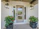 Elegant front door with sidelights and potted plants for a warm, inviting entrance at 4446 Huntington Cir, Atlanta, GA 30338