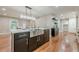 Kitchen island with a stainless sink, gold faucet, sleek black cabinets, and white countertops, perfect for entertaining at 4446 Huntington Cir, Atlanta, GA 30338