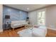 Stylish living room featuring a comfortable sofa, patterned accent wall, and natural light at 4446 Huntington Cir, Atlanta, GA 30338