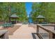 Outdoor picnic and recreation area with shelter, tables, and an oversized Adirondack chair surrounded by mature trees at 4446 Huntington Cir, Atlanta, GA 30338
